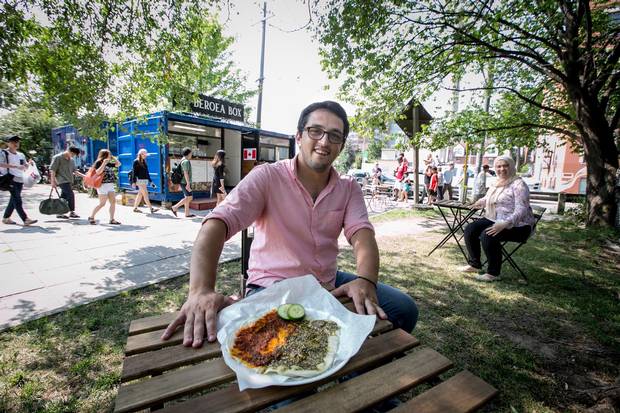 TORONTO, JULY 21, 2017 - BEROEA BOX - Syrian immigrants to Canada, Amir Fatal and his wife Nour Ammana, right, share their Halabi cuisine with the people of Toronto through their catering service and from a shipping container restaurant called the Beroea Box, found outside the Scadding Court Community Centre at the corner of Dundas Street West and Bathurst Street in Toronto. Beroea menu items include a flatbread called Manúshe which comes in several varieties such as Zaatar with a number of traditional toppings including dried thyme, sumac and sesame seeds mixed with olive oil and Mouhamara with Aleppos original sweet red pepper paste, (also made as a half and half, as seen here).