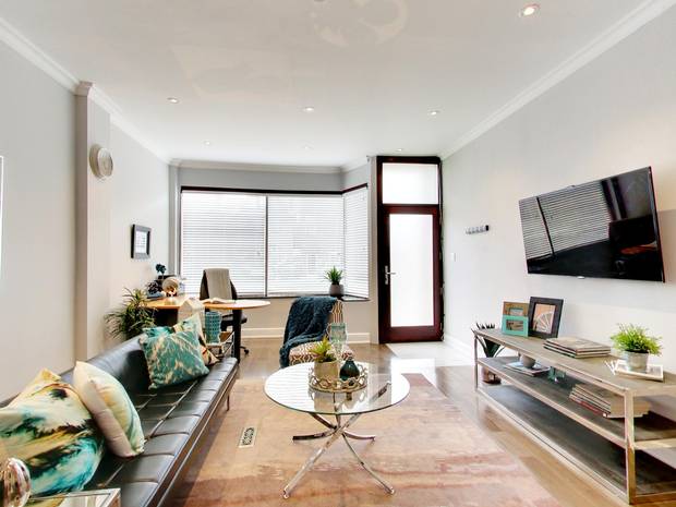 To convert the building from two units to one, they had to tear down a drywall partition separating what is now the dining room from the living room. 