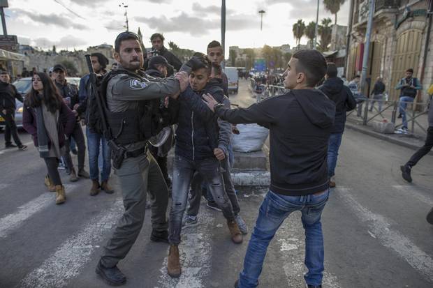Israeli police clash with Palestinian demonstrators at the Damascus Gate outside the Old City of Jerusalem on Dec. 7, 2017. 
