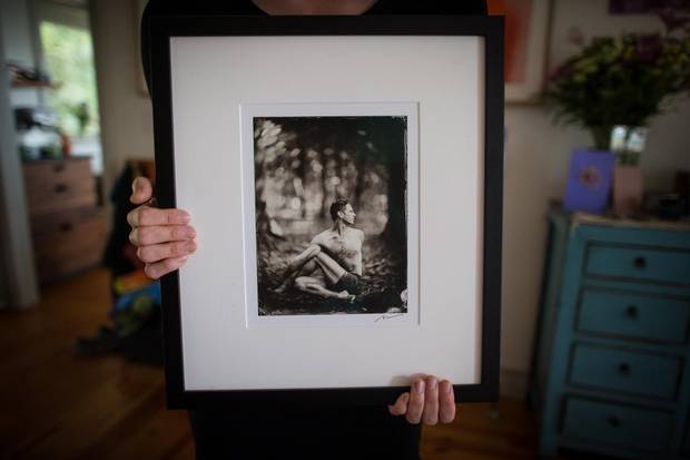 Carina Stone holds a photograph of her husband, Michael Stone.