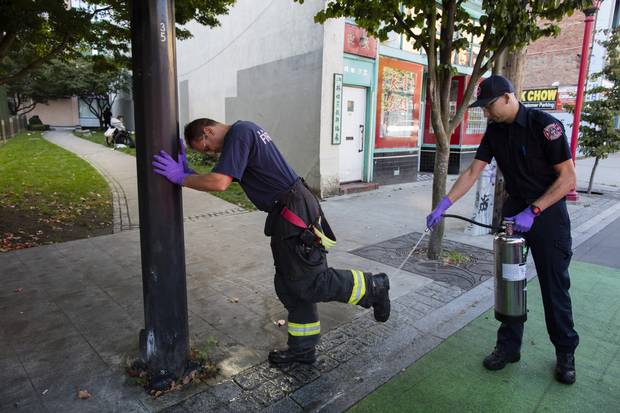 Brandon Davies, right, disinfects the boots of his lieutenant. 