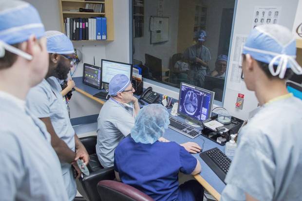 Neurosurgeon Dr. Garnette Sutherland looks over his patients scans before surgery.