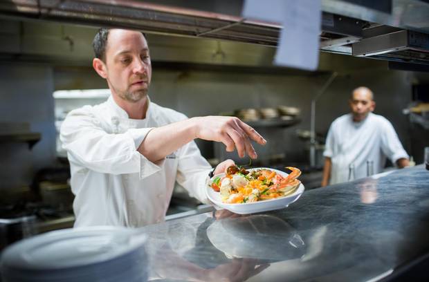 Chef de Cuisine Sheldon Maloff prepares a dish at Provence Marinaside.