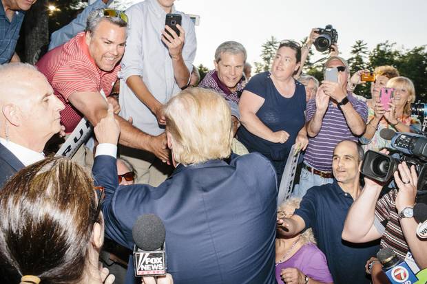 Real-estate mogul and Republican presidential candidate Donald Trump greets supporters after speaking at a rally at the Weirs Beach Community Center in Laconia, N.H.