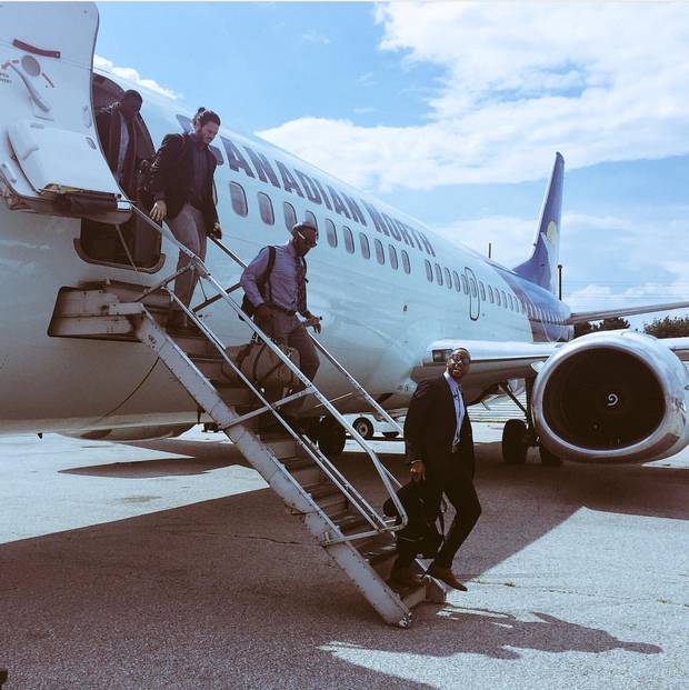 The Calgary Stampeders deboard a plane.