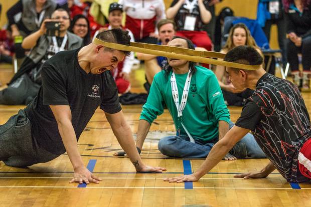 Yukon's Matthew Jacobson, left, competes against Greenland's Bent Jakobsen in the head pull. This event requires competitors to prop themselves up on their hands facing one another with a leather band wrapped around the back of their heads. The winner is the one who either pulls their competitor across a line on the ground or the band off their head.