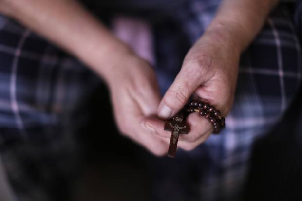 Thelma Favel, great-aunt of Tina Fontaine holds a rosary at her home on the Sagkeeng First Nation in Manitoba, February 19, 2018. The rosary helps keep Favel strong during the Fontaine trial.