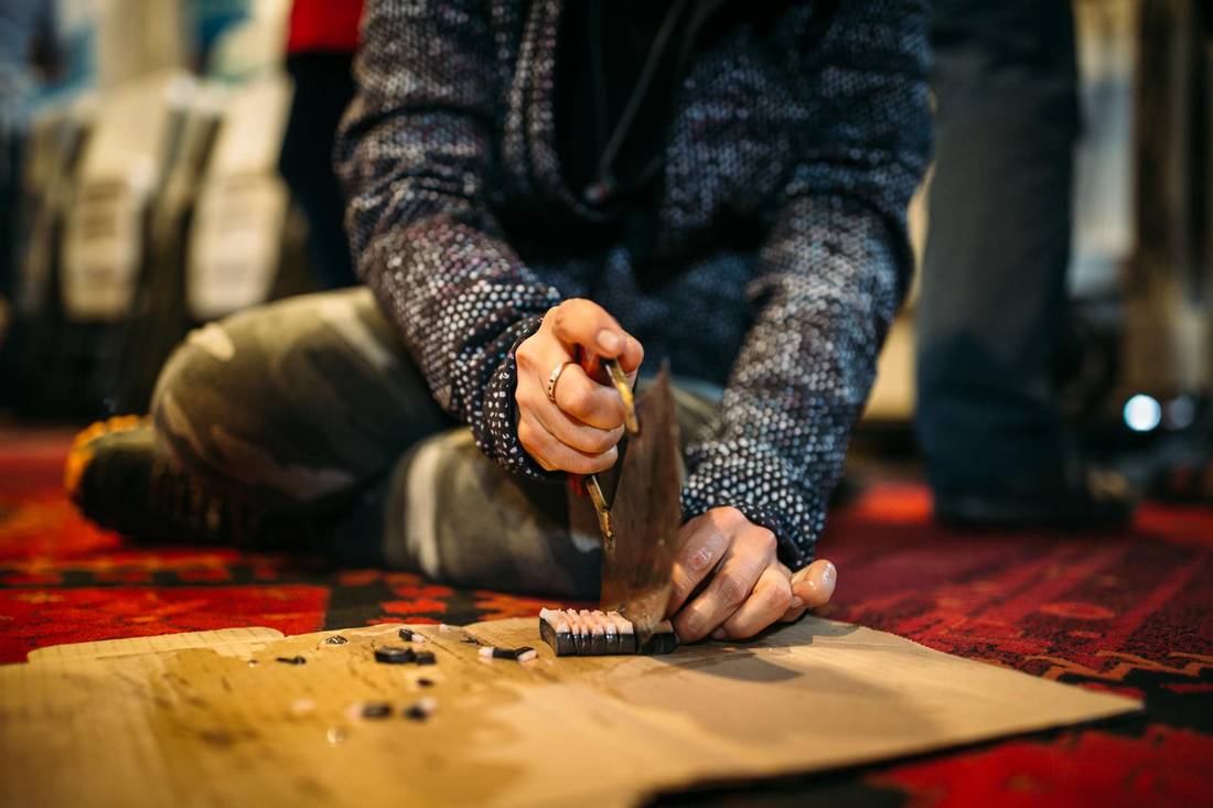Canada C3 participant Uluriaq Amarualik cuts narwhal.
