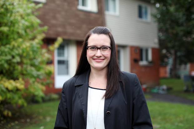 Erica Lychak stands in front of her Ottawa home.