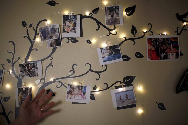 Merell Awad shows pictures on the wall from summer trips to Quadra Island.