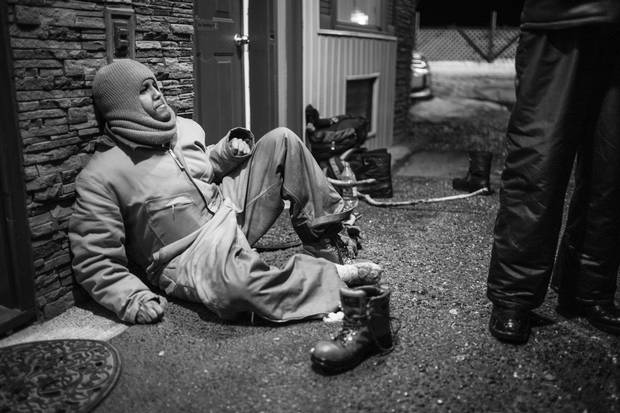 Asylum seeker Omar Ahmed tries to warm his frozen feet.