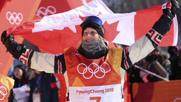 Laurie Blouin of Canada poses with Canadian flag before the flower ceremony.