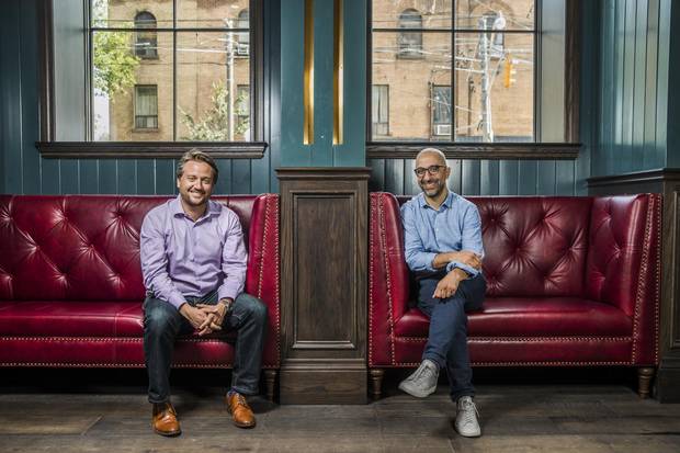 Restaurateurs Erik Joyal, left, and John Sinopoli pose for a picture at the Broadview Hotel on Wednesday, where they are launching three restaurants. The top-floor one is drawing in big crowds.