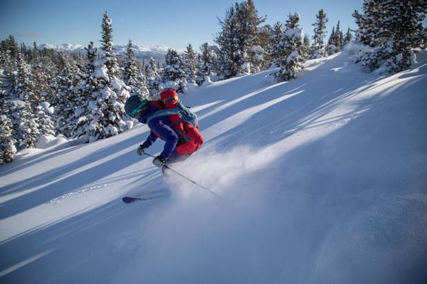 Tessa Treadway skis with her son Raffi on her back near Tweedsmuir Ski Club.