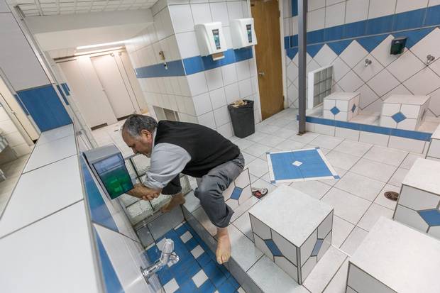 Mosque president Mohamed Labidi performs ablution before a prayer at the mosque.