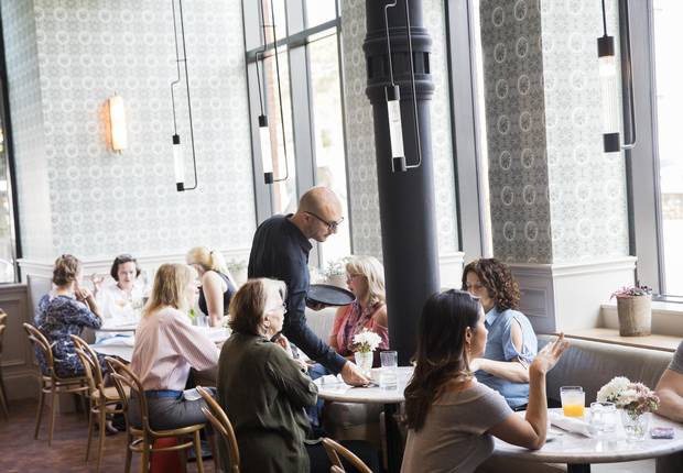 People sit in the cafe at the Broadview Hotel in Toronto.