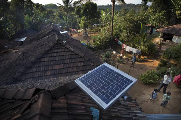 Solar panels sit on houses in Paradeshappanamatha, India.
