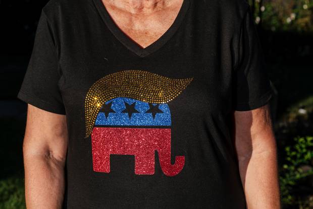 Lynette Villano, 70, shows off one of her many pieces of Trump memorabilia.