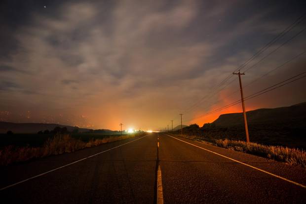 Smoke hangs in the air above the Trans-Canada Highway as wildfires burn on mountains near Ashcroft, B.C., last Friday.