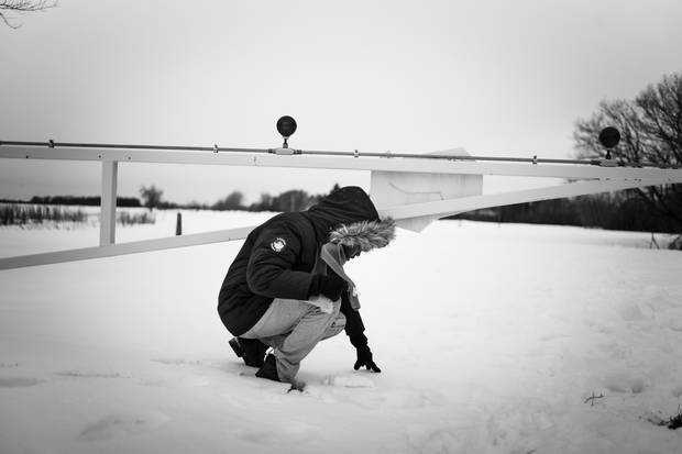 Delmar Xasan goes under a road block to enter Canada.