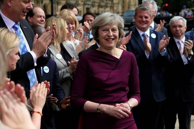 Britain's Home Secretary, Theresa May, is applauded as she makes a statement outside the Palace of Westminster, in London, after she won 199 votes for the Conservative leadership, Thursday July 7, 2016. Andrea Leadsom took 84 votes and Michael Gove took 46, meaning the UK's next prime minister will be a woman. (Jonathan Brady/PA via AP)
