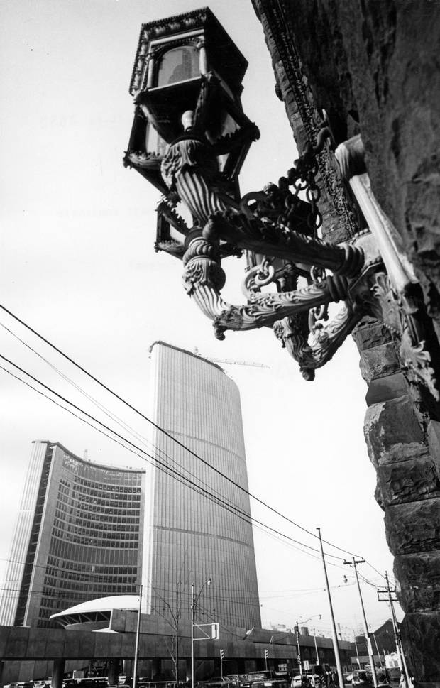The intricate design of Toronto’s old city hall building, right, contrasts with the streamlined shape of the new.