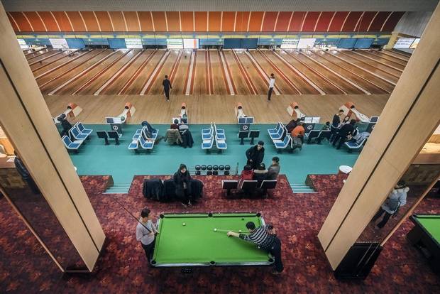The last stages of a pool game play out against a soundtrack of strikes, spares and gutter balls at a bowling alley in East Pyongyang. With a standard six-day work week in North Korea, Sunday is the day for relaxation.