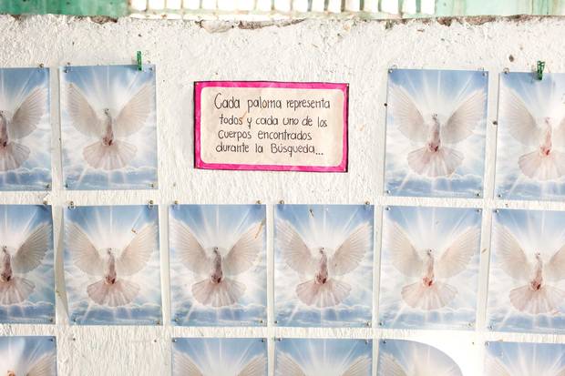 A wall of doves lines church walls in Iguala at the searchers’ headquarters. The family members of missing people put a dove up for every body they find in a clandestine grave.