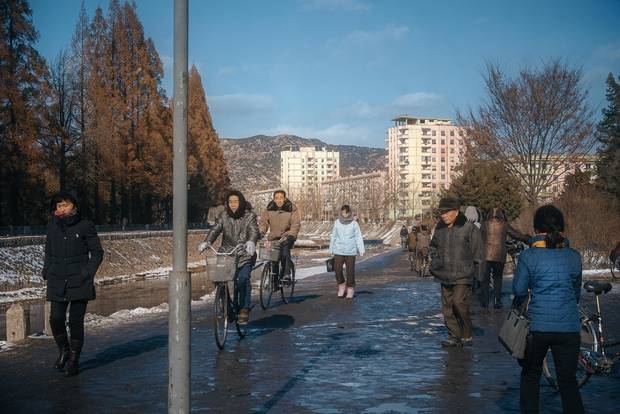 Cyclists and pedestrians share a pathway during the peak morning commute in Kaesong, a city of 200,000 near the border with South Korea.