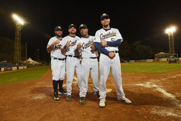 Posing for a group photo are from left Ismel Jimenez, Yordan Manduley, Alexei Bell, and Yuniesky Gurriel. Four Cuban baseball players were legally allowed to leave the country to play baseball in Canada for the Quebec Capitales. This is a new venture for Cuba which is now only beginning to see a thaw in it's relationship with the United States.