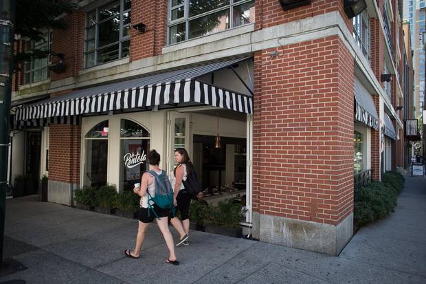 People walk past La Pentola at the Opus Hotel, in Vancouver, B.C.
