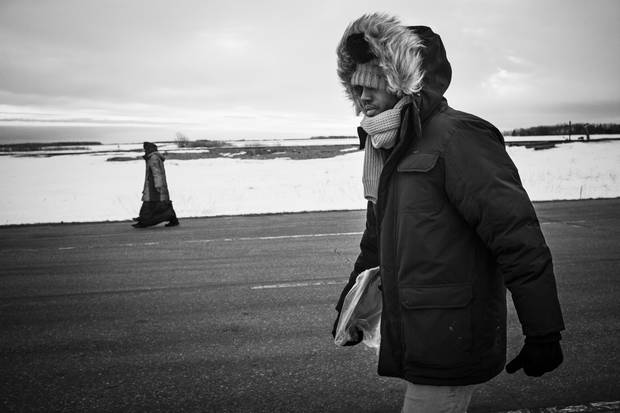 Lul Abdi Ali and Delmar Xasan walk north toward Canada.