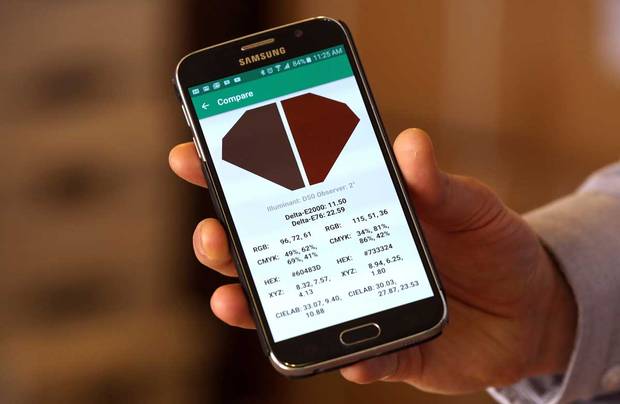 An app on a smartphone is used with the Nix Sensor, a hand-held device that can read colours of food and non-food products, at the company offices in Hamilton on May19, 2016.