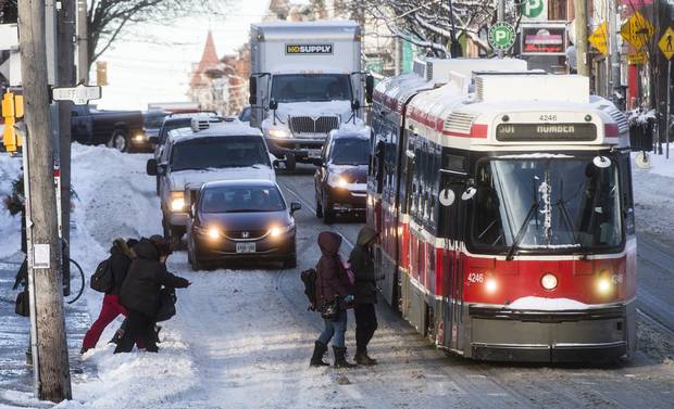 People board a TTC streetcar after a snowstorm in Toronto.
