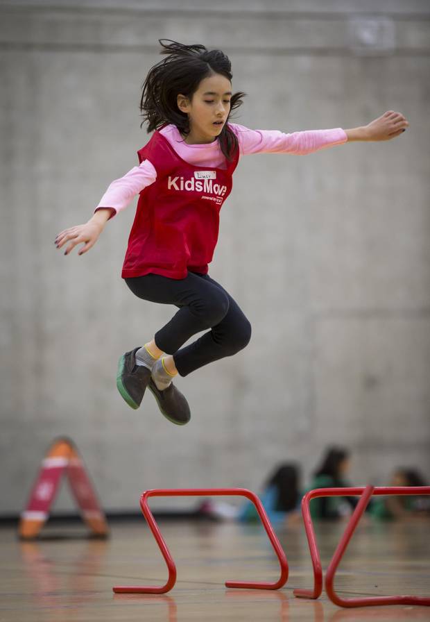 Lucy Neville-Hadley, 10, a grade 6 student at Grandview Elementary School, leaps over an obstacle while participating in the KidsMove program at the Fortius Sport & Health facility in Burnaby, B.C.,