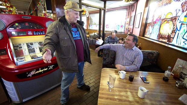 Jason Kenney chats with Garth Shewchuk, left, while having lunch at the Blackfoot Truckstop Diner in Calgary in December, 2016.