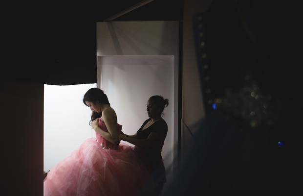 Yanahi Demetrio, a 14-year-old girl from Mexico City, tries on a dress by Amaraby at 15Fest. Yanahi had not yet decided on her dress.