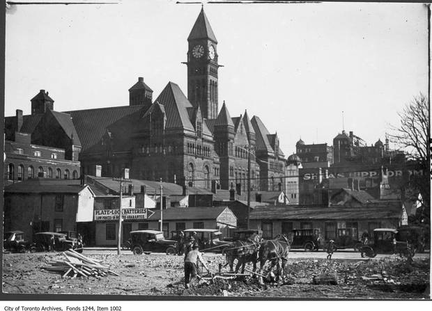 Taken May 15, 1913, by Arthur Goss. The location may be Eaton's parking lot. The team of horses may be clearing a site for a new building.