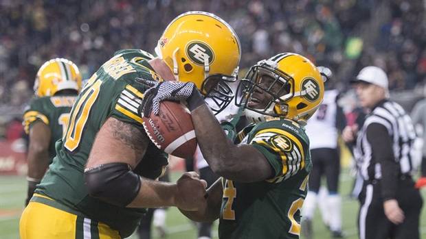Edmonton Eskimos' Akeem Shavers, right, celebrates his touchdown with teammate Justin Sorensen during the 103rd Grey Cup. THE CANADIAN PRESS/Ryan Remiorz