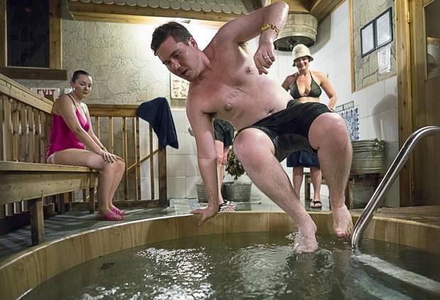 Holden Mohring jumps into a cold pool as wife Laura Meadows watches at South-Western Bathhouse in Mississauga earlier this month.