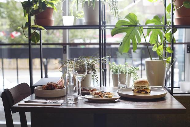 Chicken wings, a double beef burger, pork skewer and baked oysters at Wishbone in Edmonton