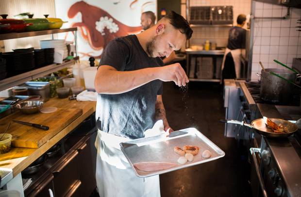 Oddfish Chef Tristan Chisholm prepares fish on a plancha griddle.