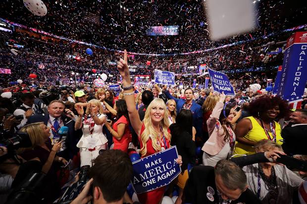 Delegates stand and cheer at the end of the Republican National Convention on July 21, 2016, at the Quicken Loans Arena in Cleveland, Ohio.