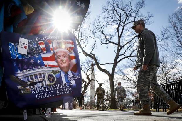 Military personnel walk along the National Mall in Washington on Wednesday - days before Donald Trump’s presidential inauguration.