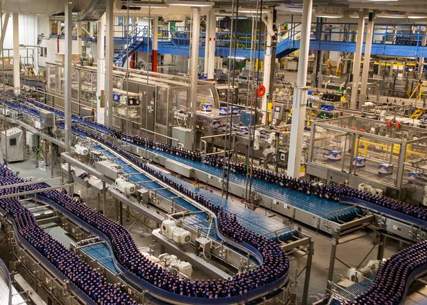 Bottles of Alpine Lager move on the packaging line.