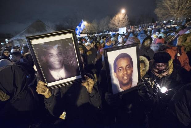 Mourners hold up photos of the mosque-shooting victims on Jan. 30, 2017, in Quebec City.