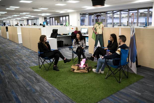 Employees sit around a faux campfire at the Intelex office at the company’s Toronto office. A digital strategy is so important to Intelex’s decision making because “the massive intelligence that it’s going to take to stop global warming and bring temperatures down even one degree is going to come from beyond these walls,” says Mark Jaine, who heads the company.
