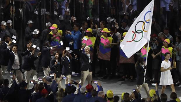 Rose Lokonyen Nathike carries the flag of Refugee Olympic Team during the opening ceremony for the 2016 Summer Olympics in Rio de Janeiro, Brazil, Friday, Aug. 5, 2016.