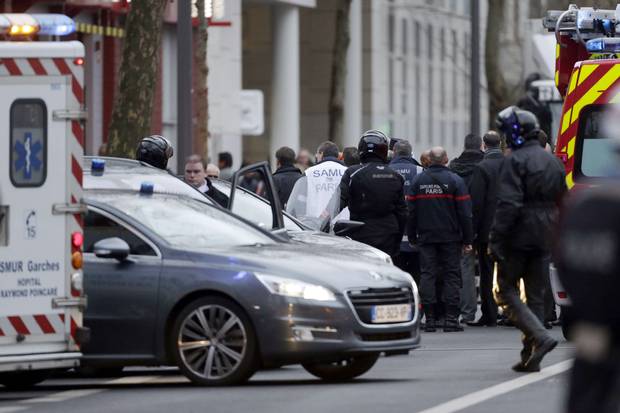 Police officers, firefighters and rescue workers gather at the site of a shooting on the morning of Jan. 8, 2015, in Montrouge, south of Paris.