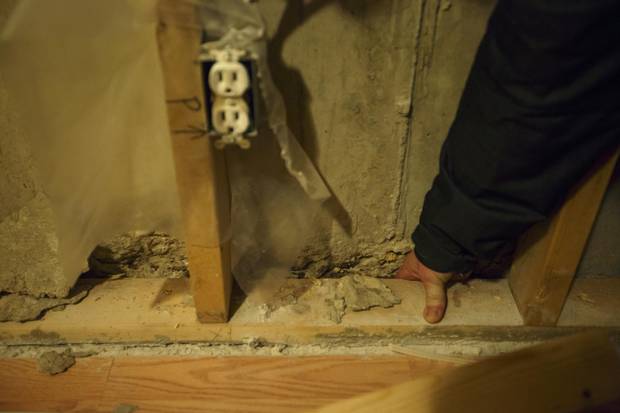 Kirby Byrne shows major new foundation issues after the family was forced to move out of their house in Fort McMurray, Alberta on Wednesday, Feb. 15, 2016.